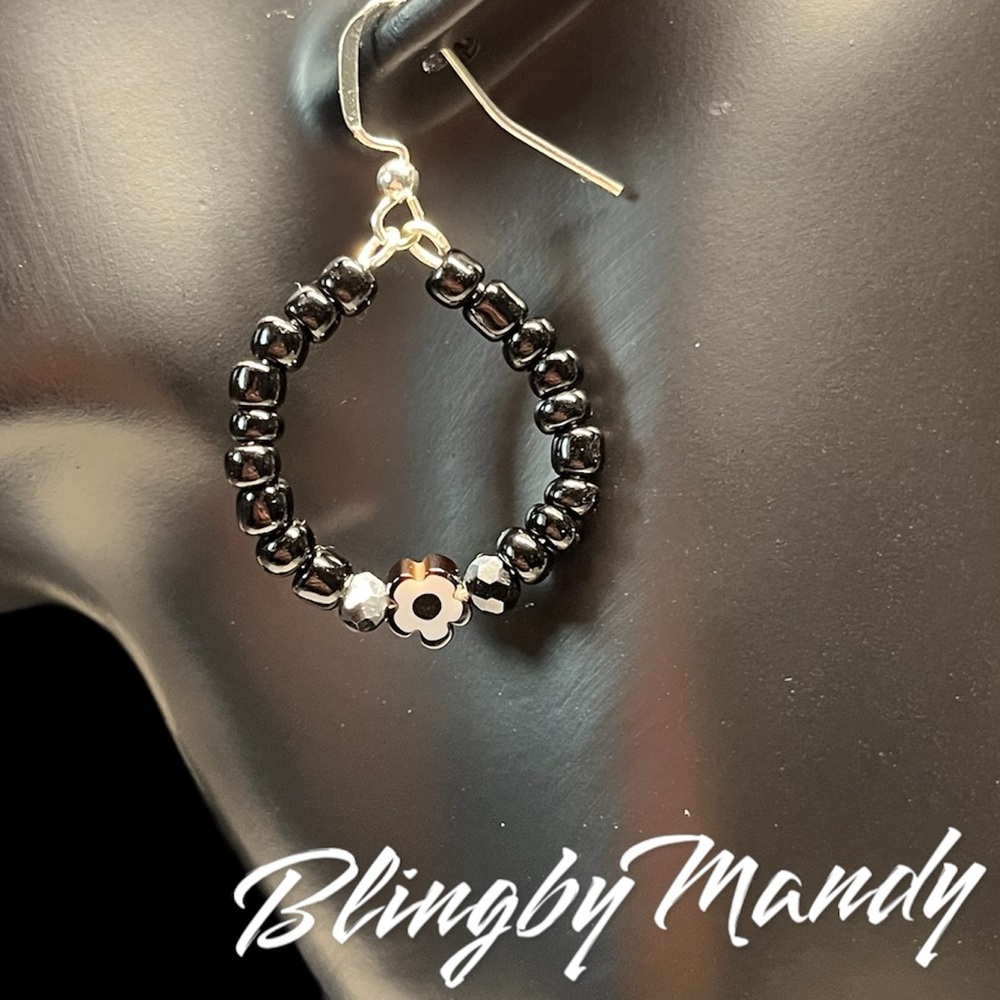 Pretty black beaded and daisy hoop earrings with silver